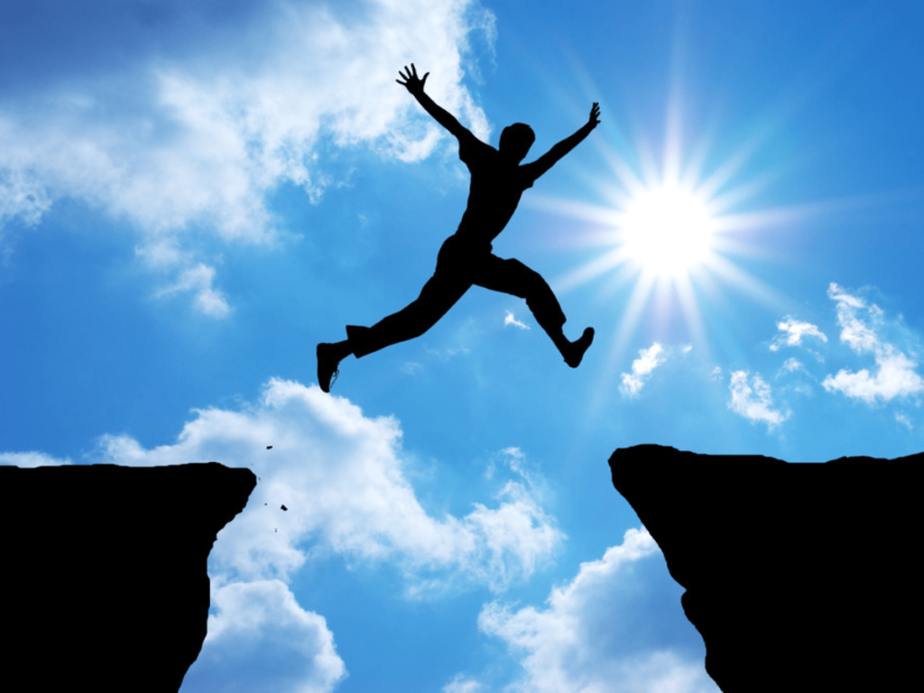 Man Jumping Over Rocks